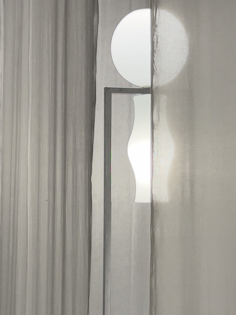 Photography of sheer curtains with soft daylight passing through a window, creating circular light shapes and a calm interior mood.